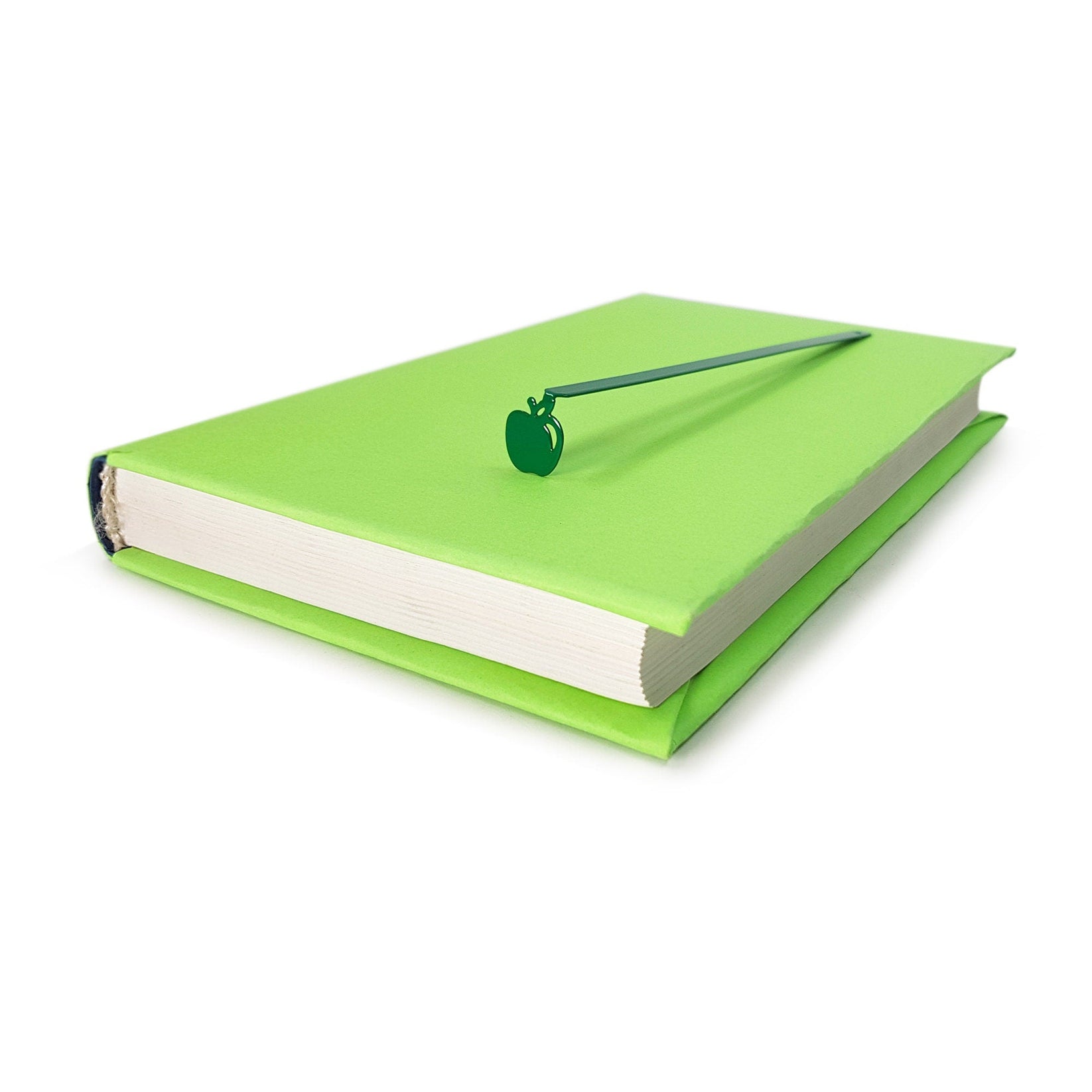Paradise Apple' metal bookmark in green clipped in a closed book, viewed from the side