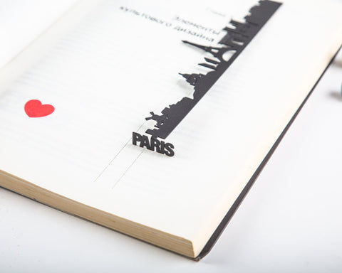 Paris metal bookmark resting on the pages of an open book