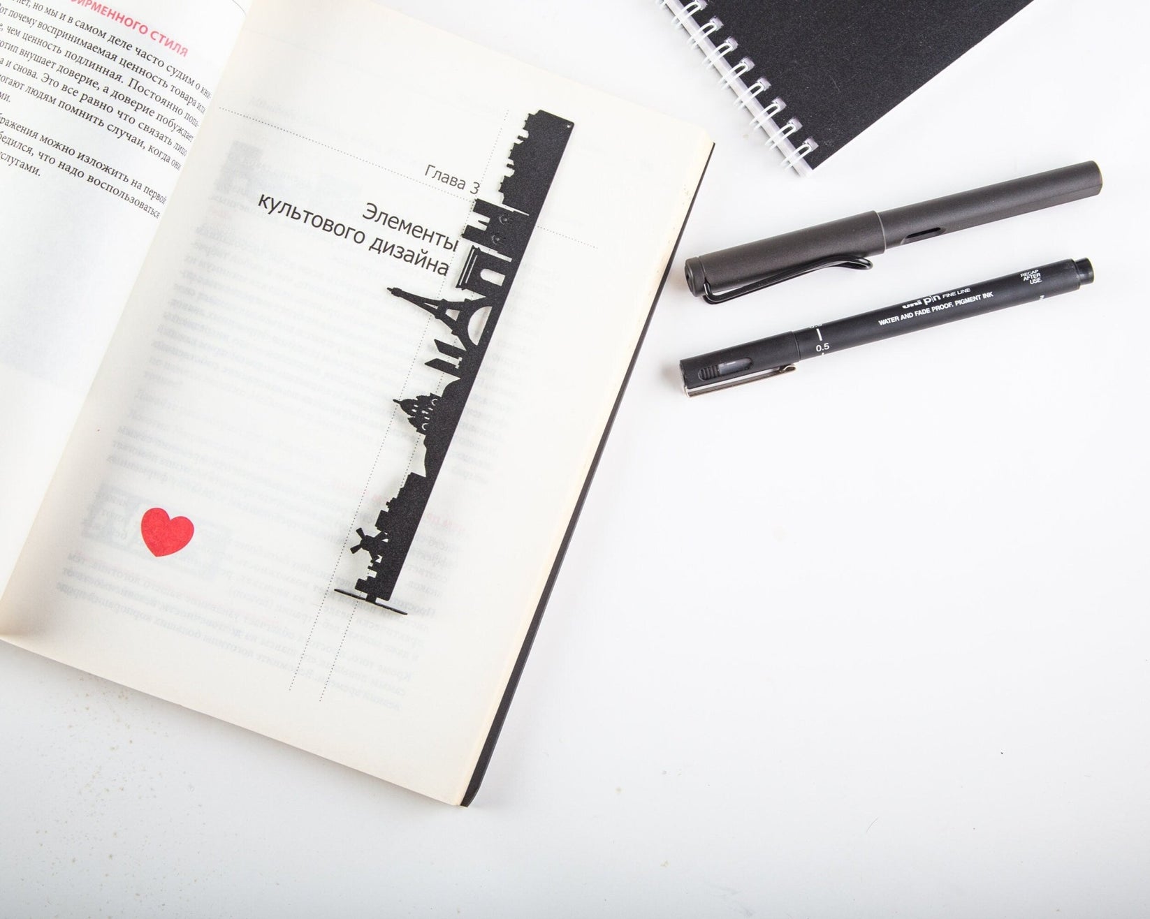 Paris metal bookmark set into the gutter of an open book