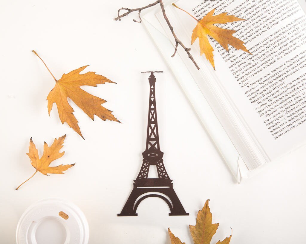 Paris Eiffel Tower metal bookmark marking a page in an open book