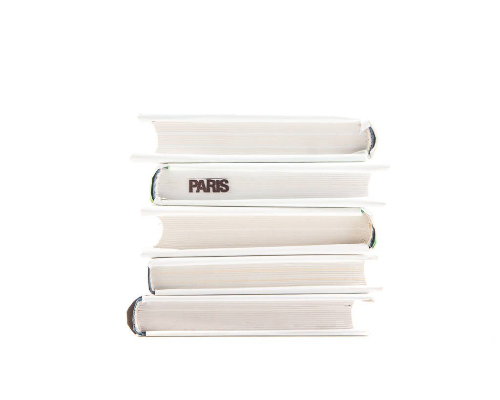 Paris Eiffel Tower metal bookmark shown with a stack of books