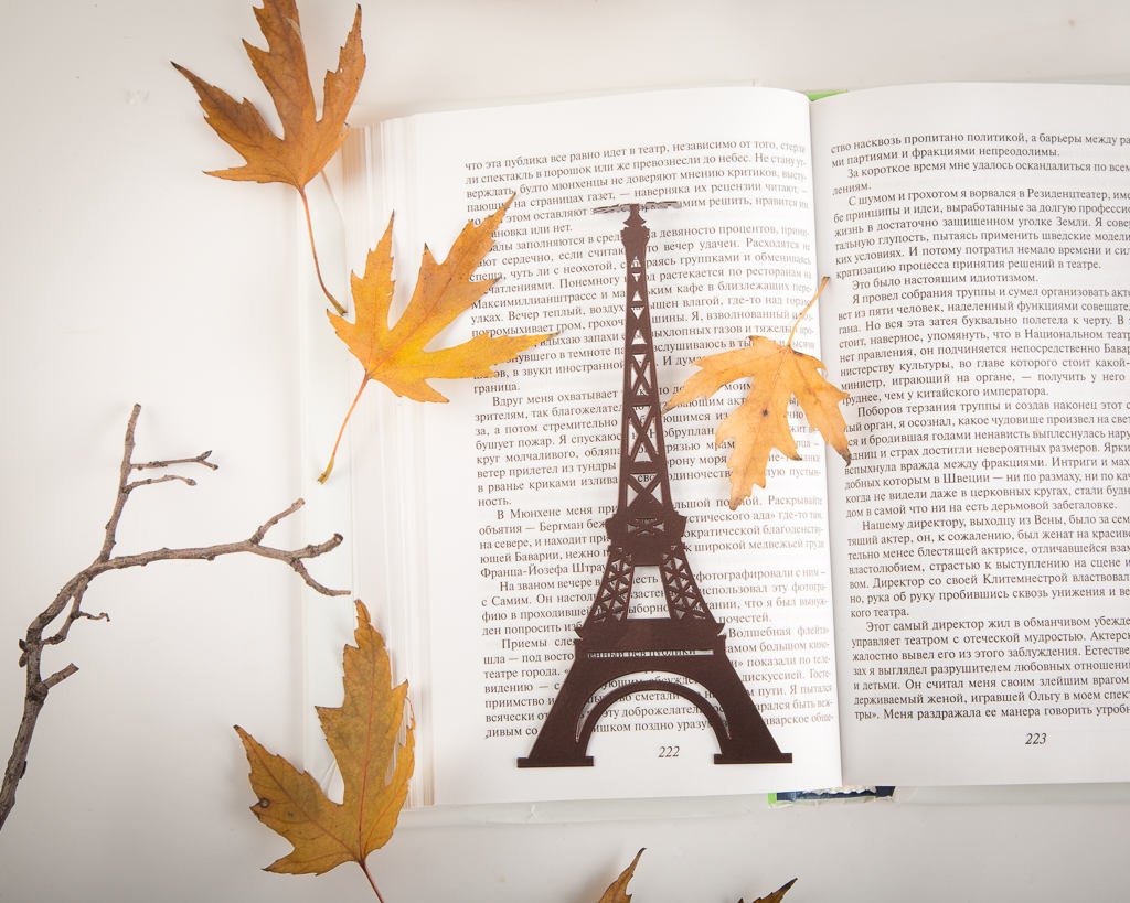 Paris Eiffel Tower metal bookmark resting on the pages of an open book