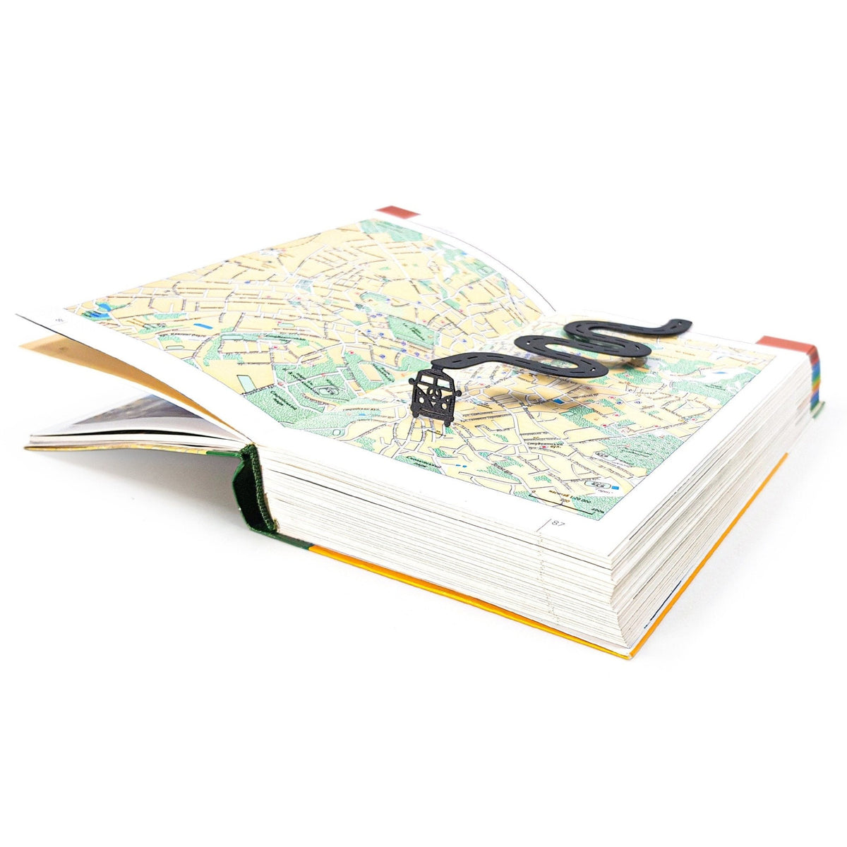 Peace Trip metal bookmark resting on the pages of an open book