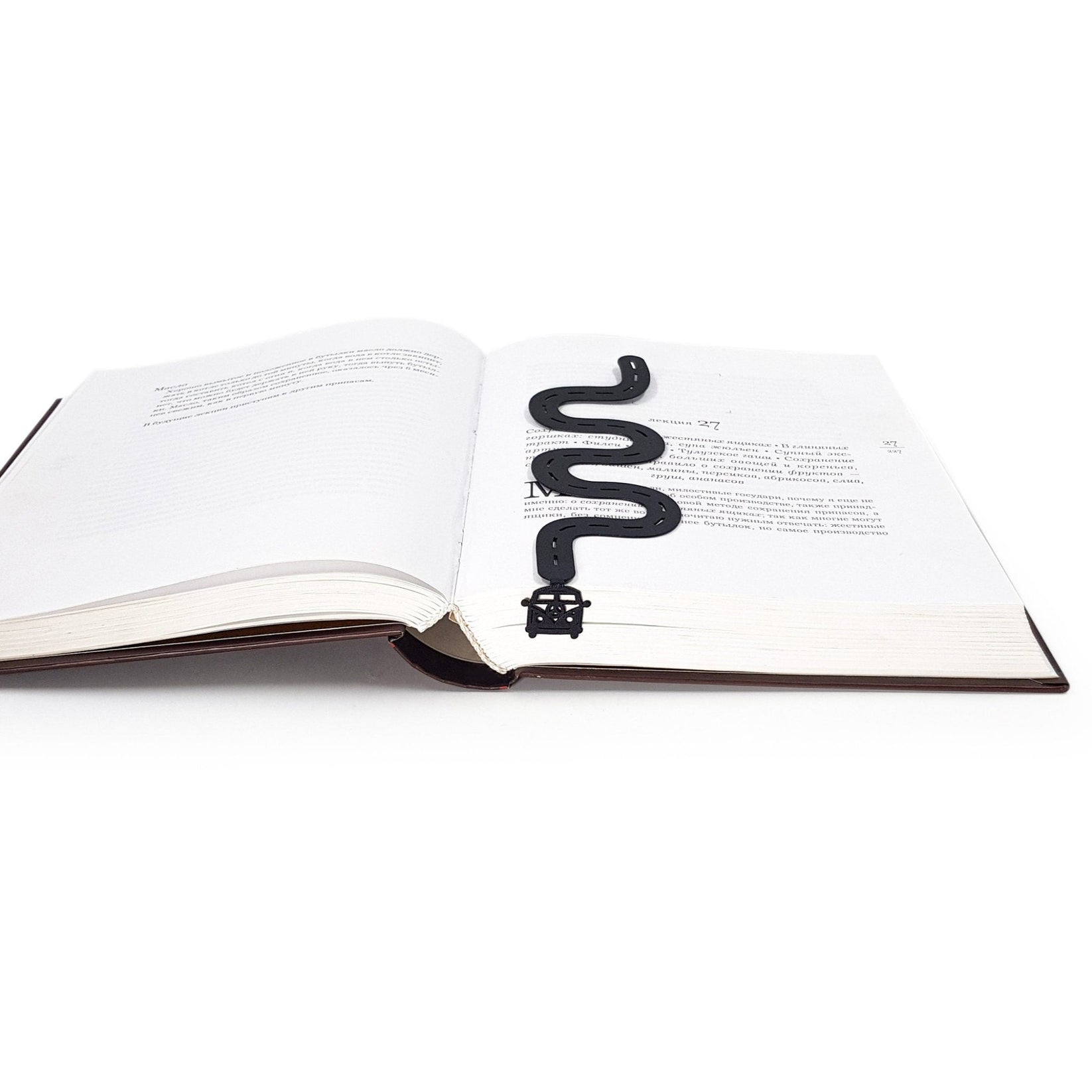 Peace Trip metal bookmark marking a page in an open book