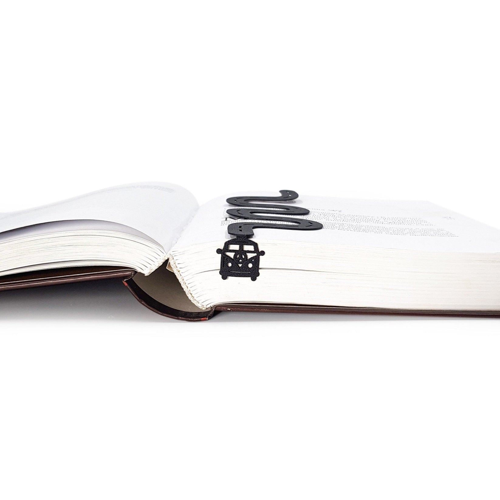 Peace Trip metal bookmark lying across the pages of an open book