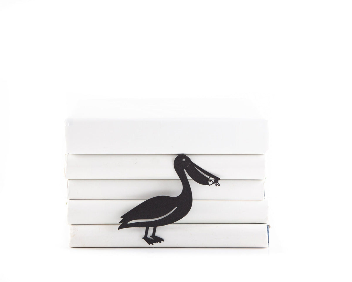 Pelican metal bookmark shown with a stack of books