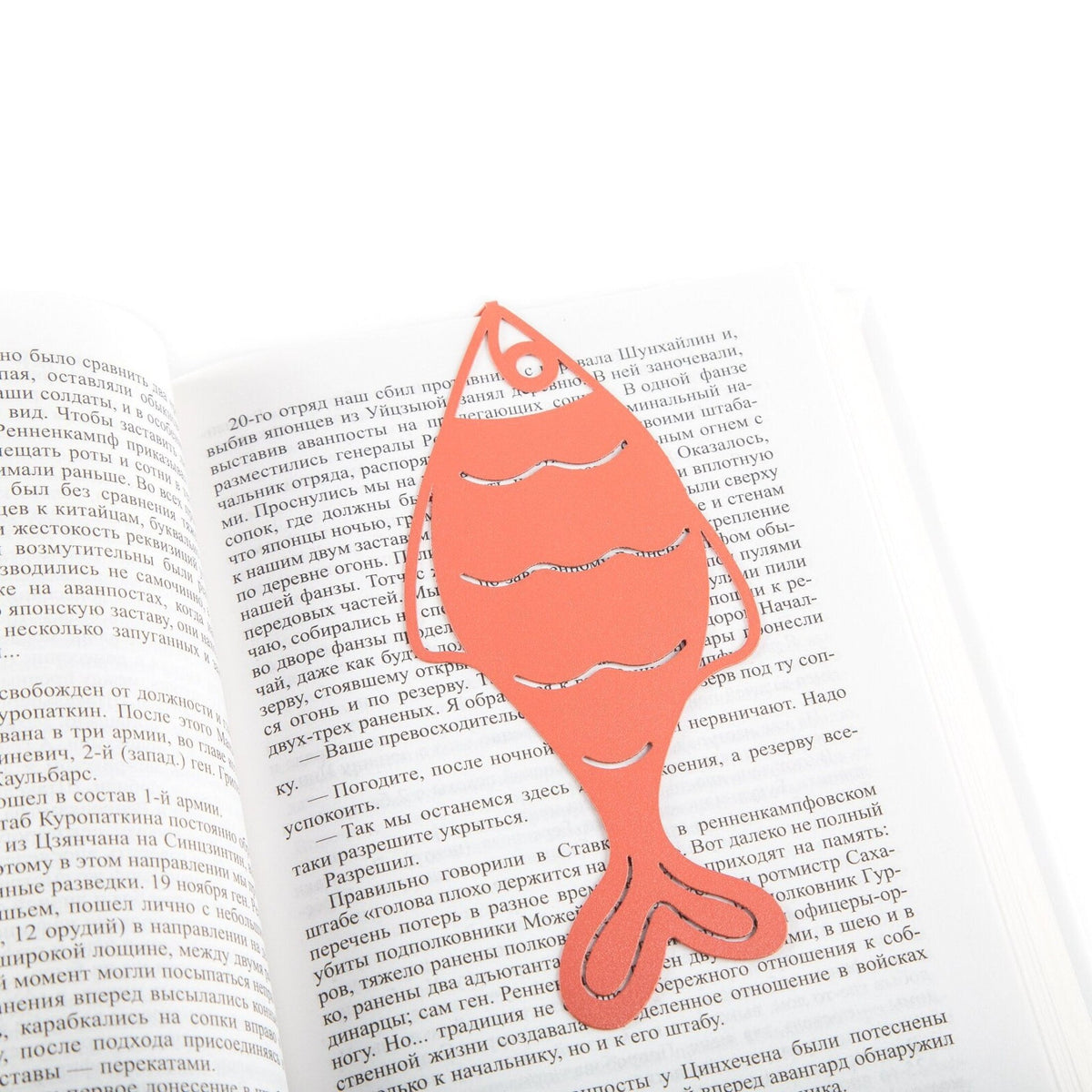 Perch metal bookmark in red set into the gutter of an open book