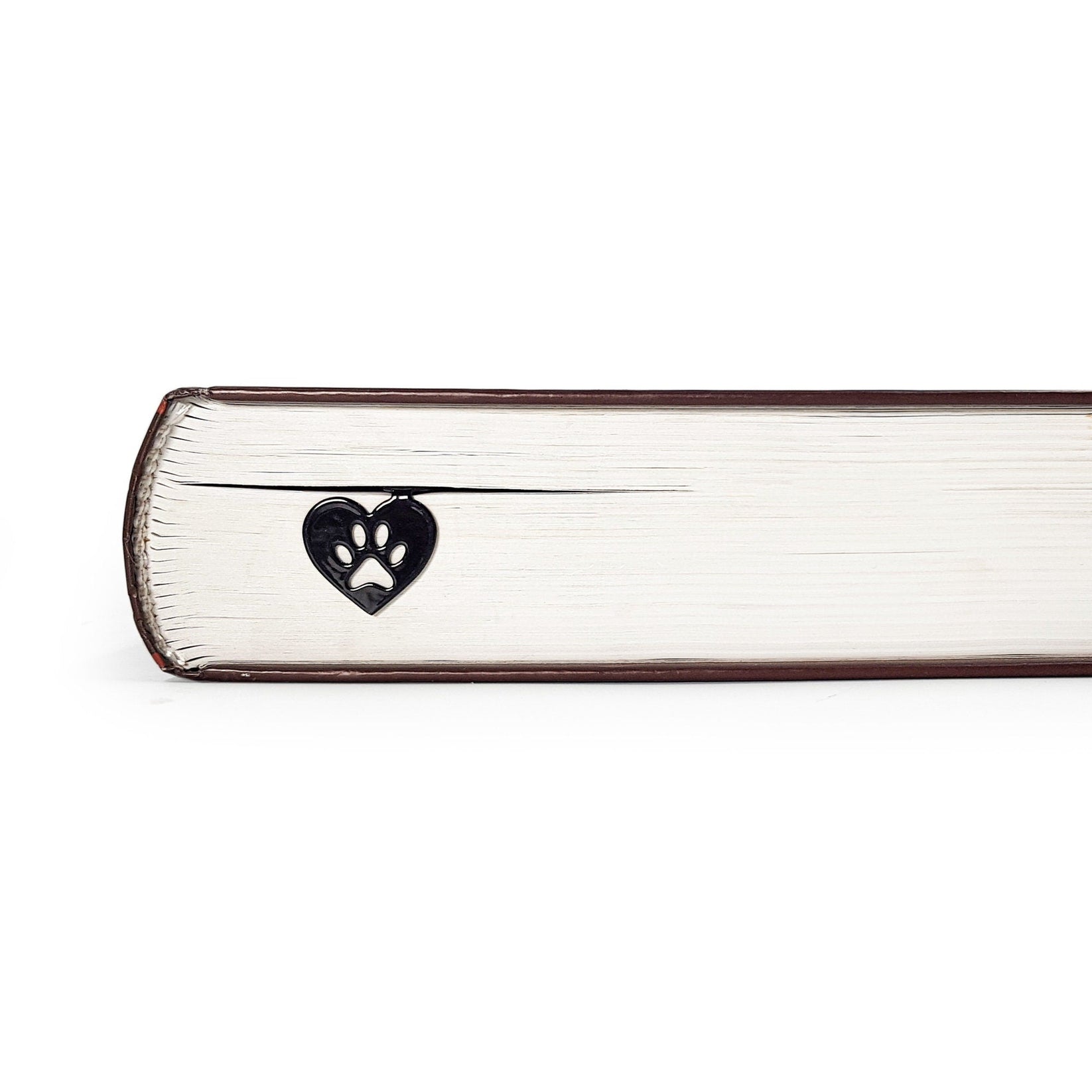 Pet Love metal bookmark in a closed book, only its top showing above the pages