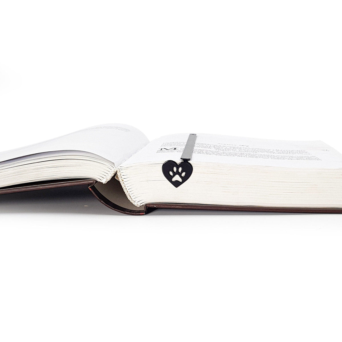 Pet Love metal bookmark marking a page in an open book