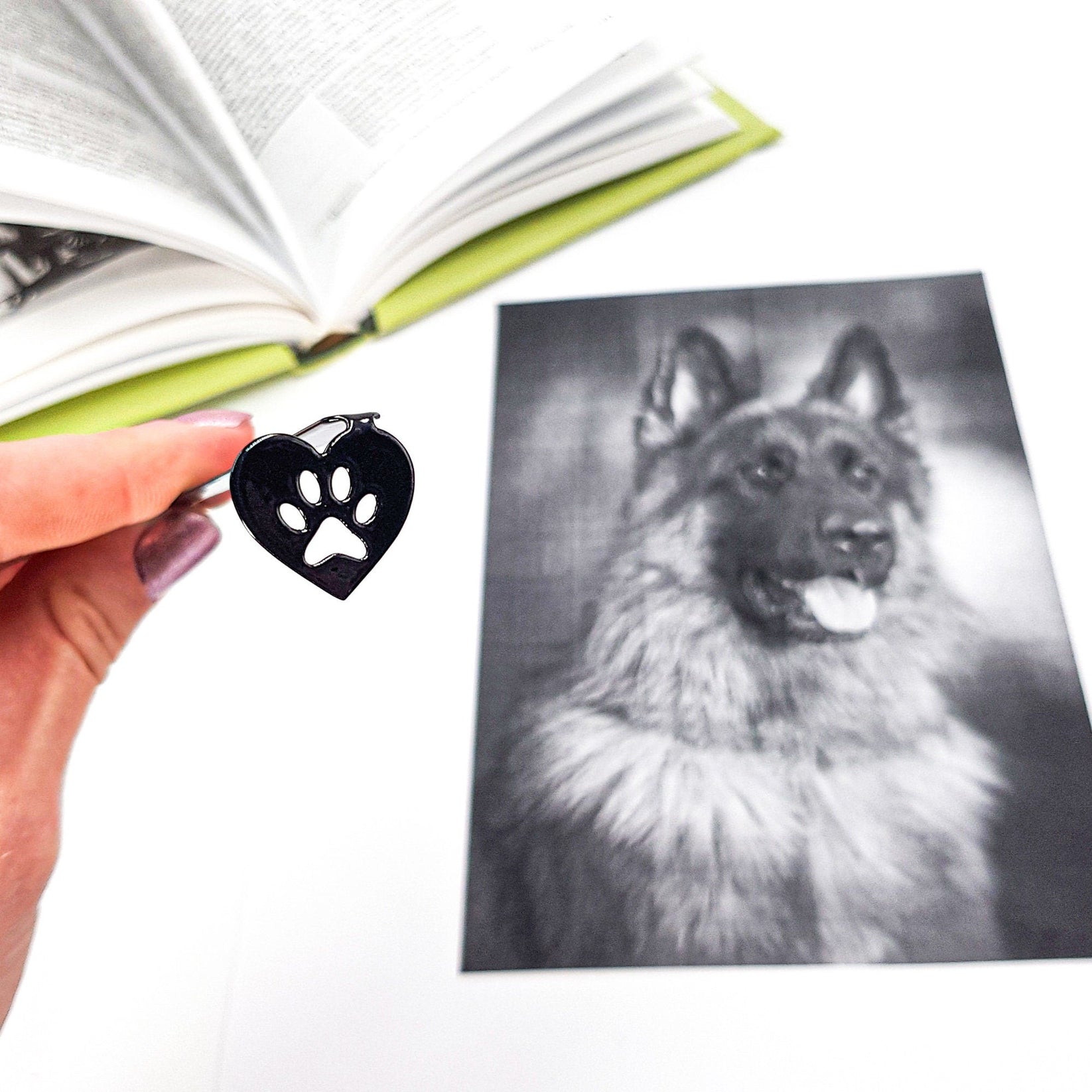 Pet Love metal bookmark marking a page in an illustrated book