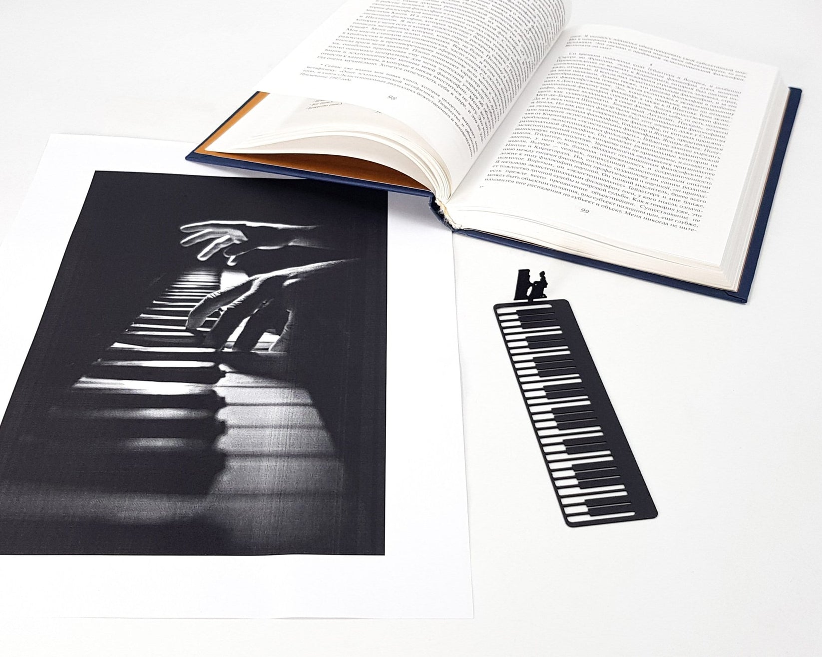 Piano Player metal bookmark on an illustrated page