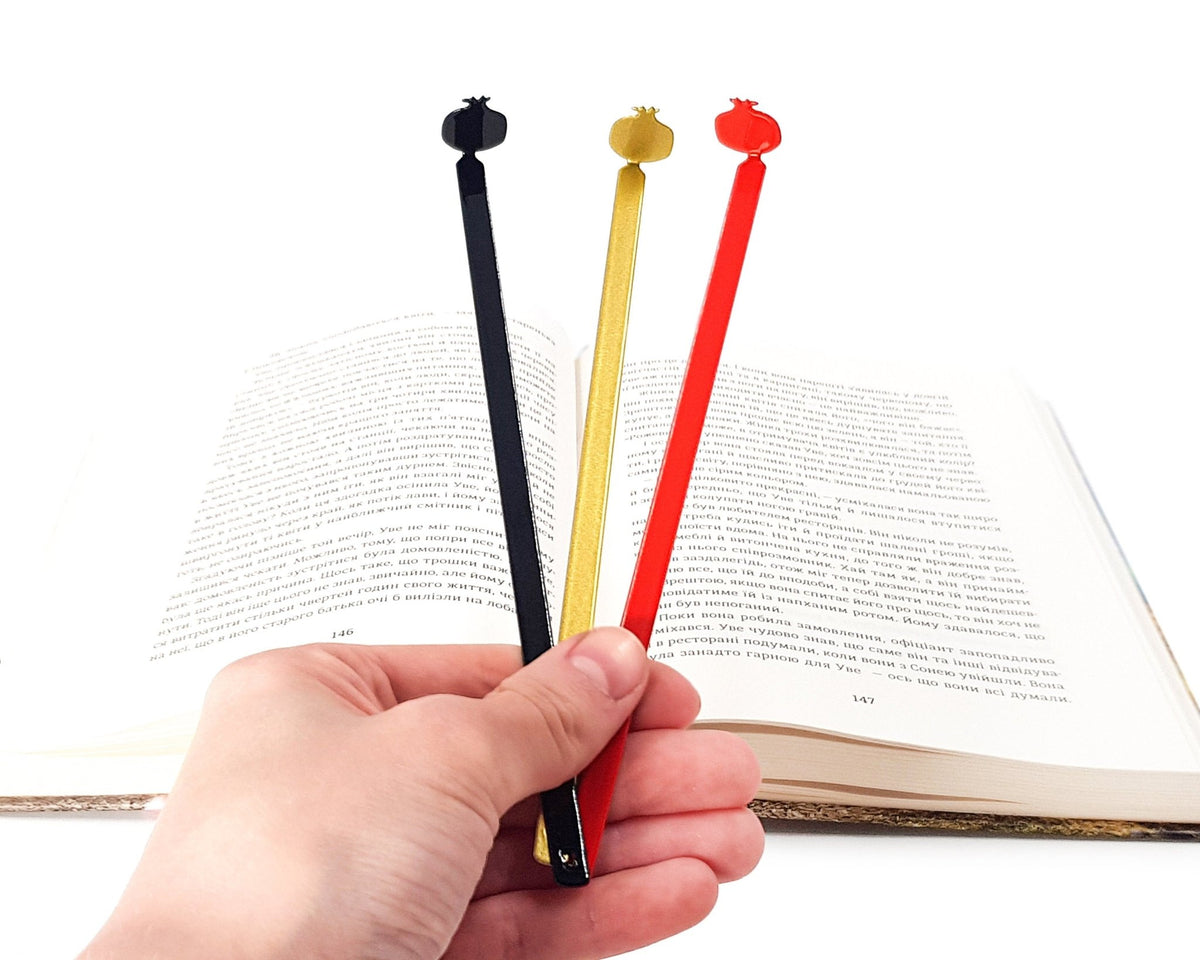 Pomegranate metal bookmark shown together with other bookmarks from the range
