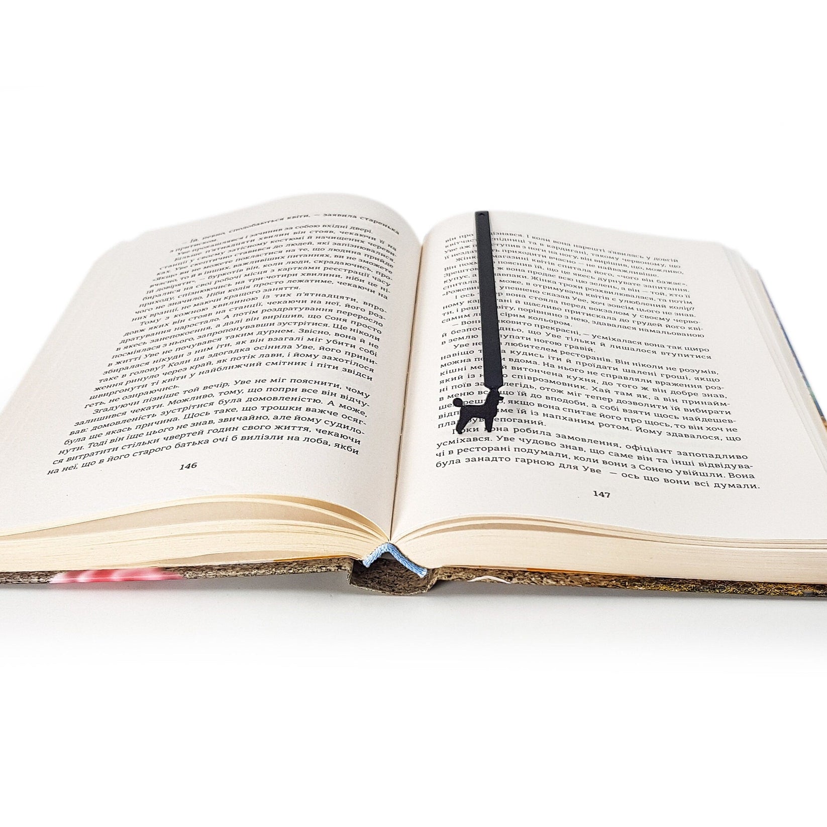 Poodle metal bookmark resting on the pages of an open book