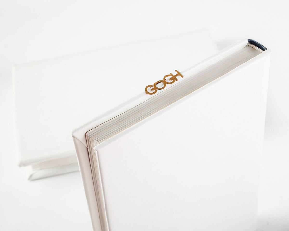 Van Gogh Portrait metal bookmark in gold seen from the edge of a closed book
