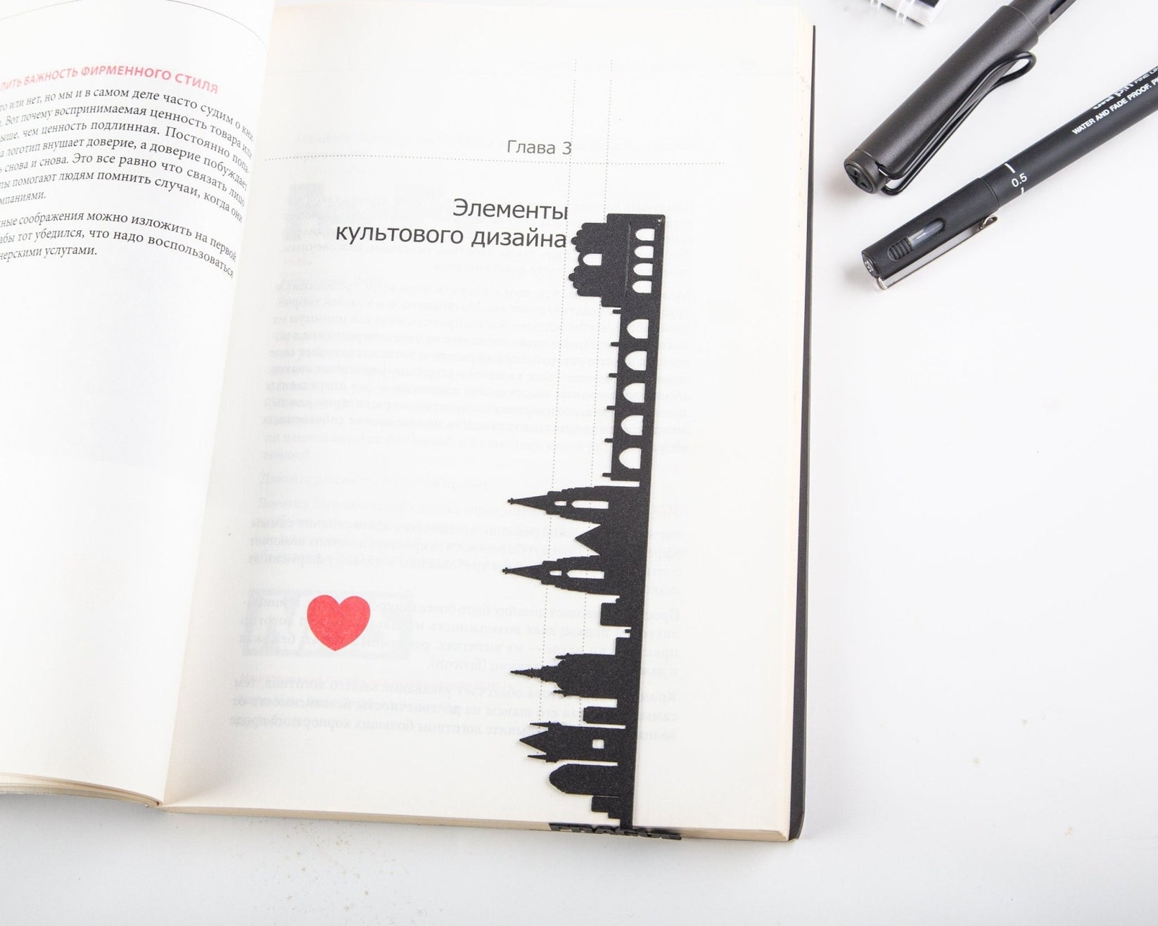 Prague Cityscape metal bookmark marking a page in an open book