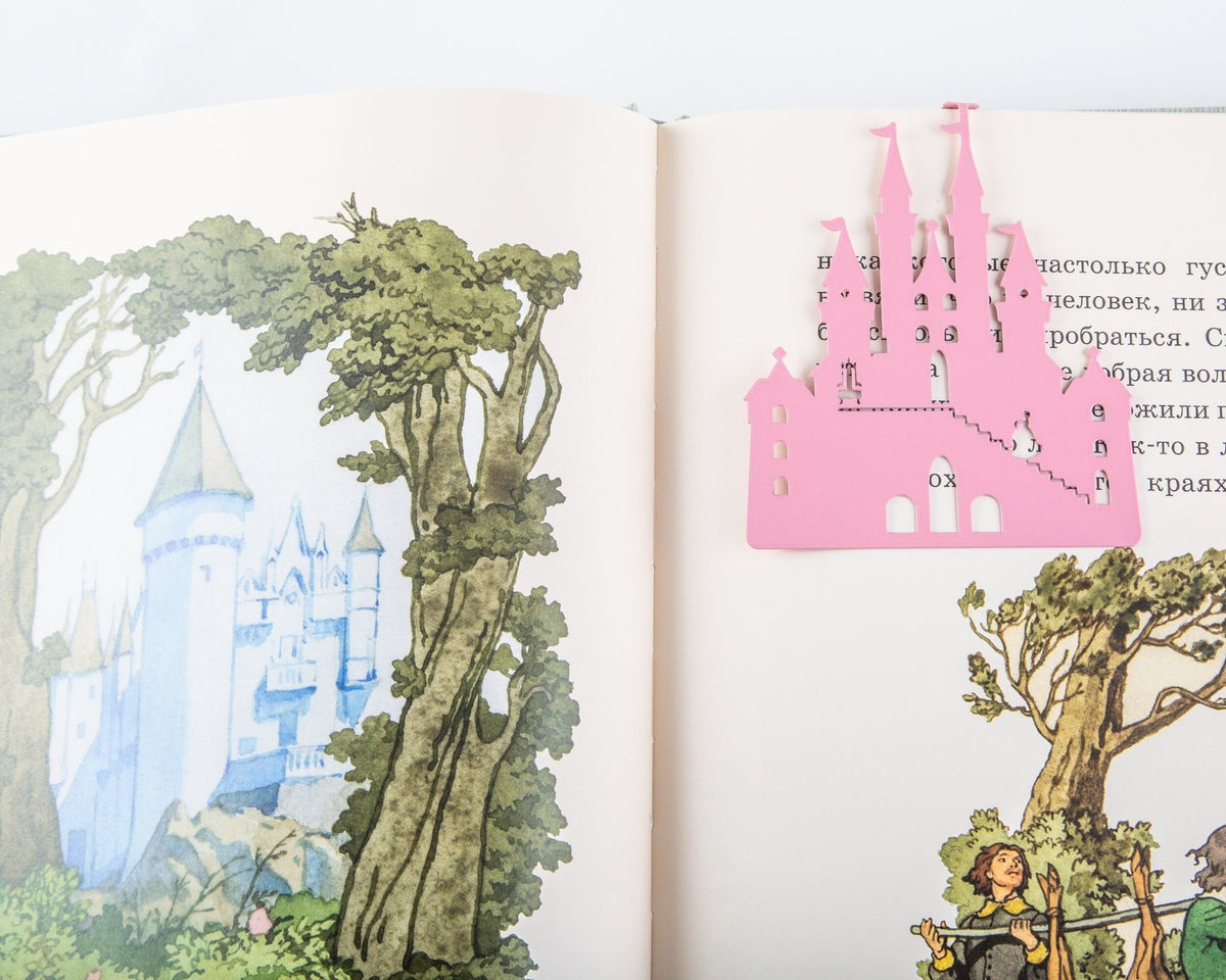 Princess Castle in Pink metal bookmark in red marking a page in an illustrated book