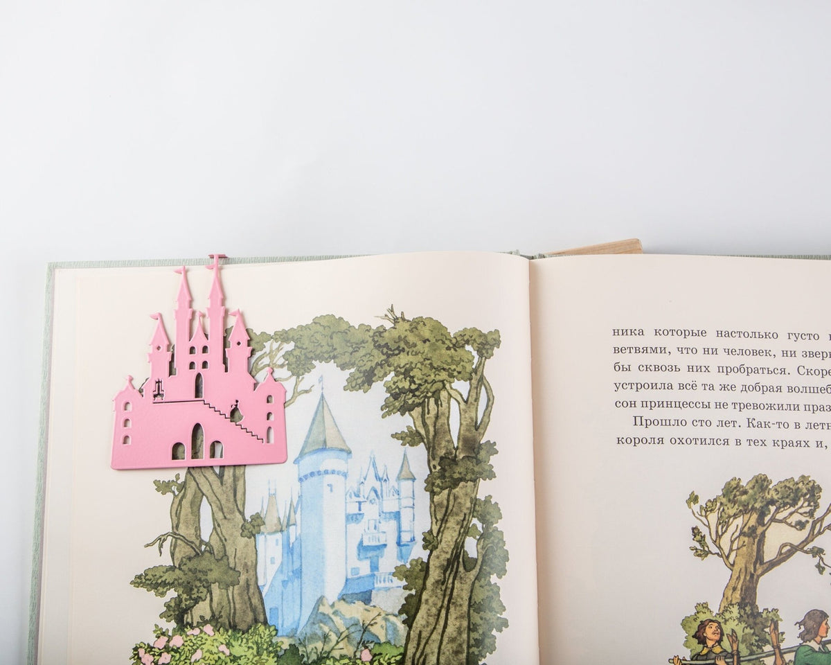 Princess Castle in Pink metal bookmark in red marking a page in an illustrated book, view 4