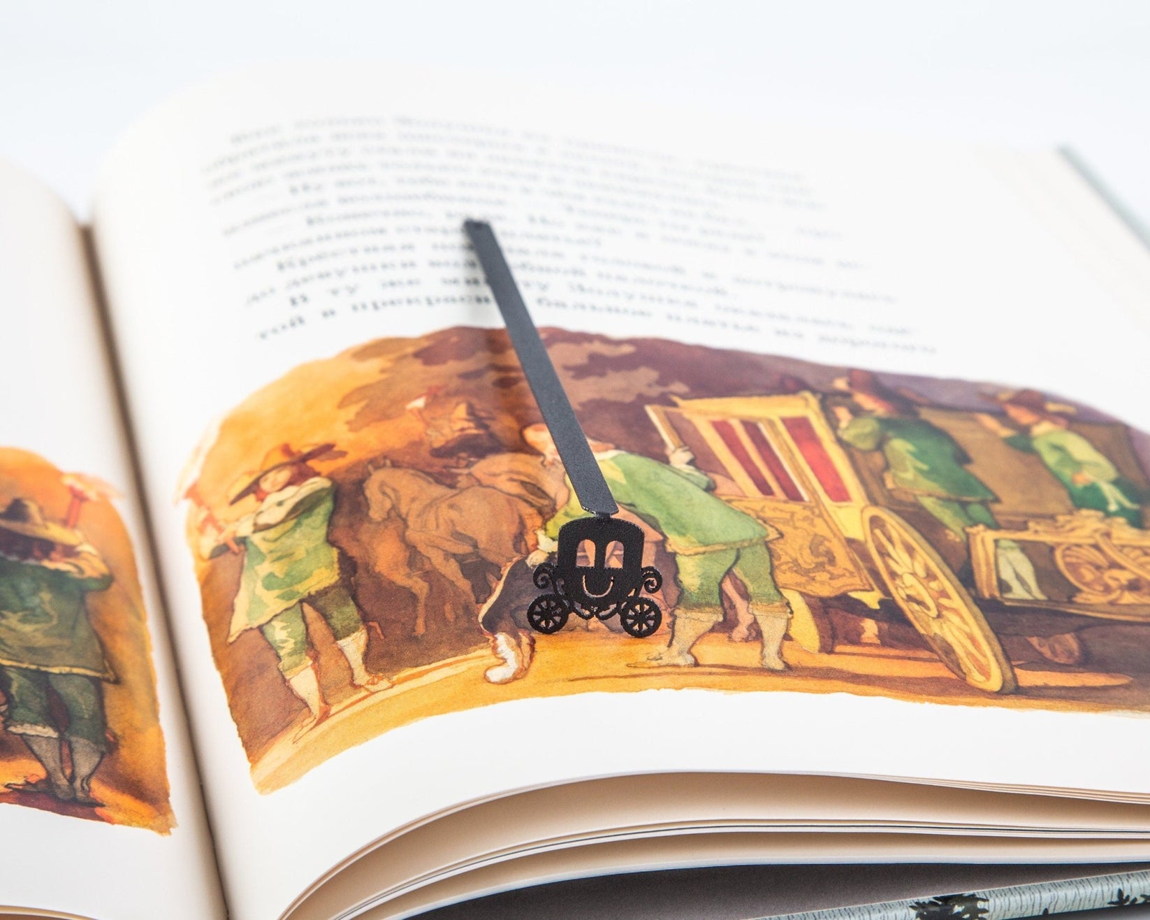 Princess's Carriage metal bookmark marking a page in an illustrated book