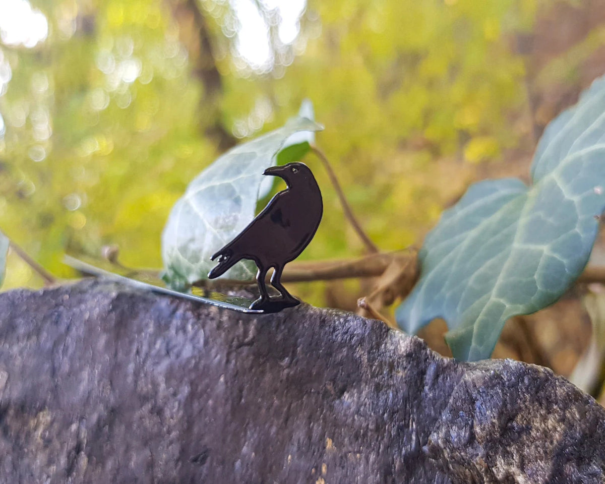 Raven metal bookmark — bookmark outdoors on mossy rock