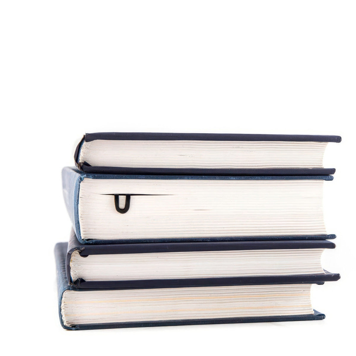 Read Here metal bookmark shown with a stack of books