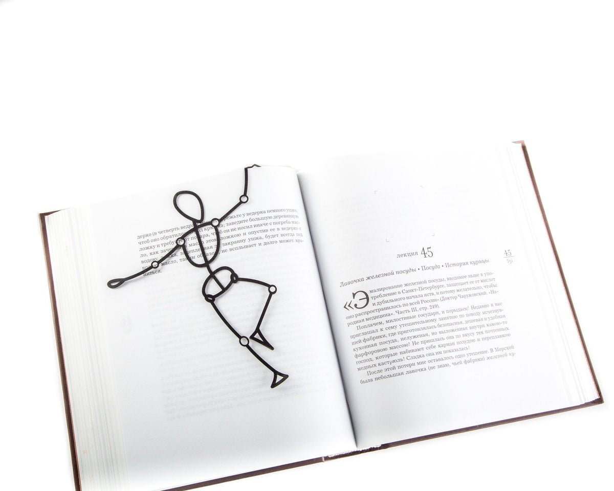 Reading Dummy Model metal bookmark resting on the pages of an open book