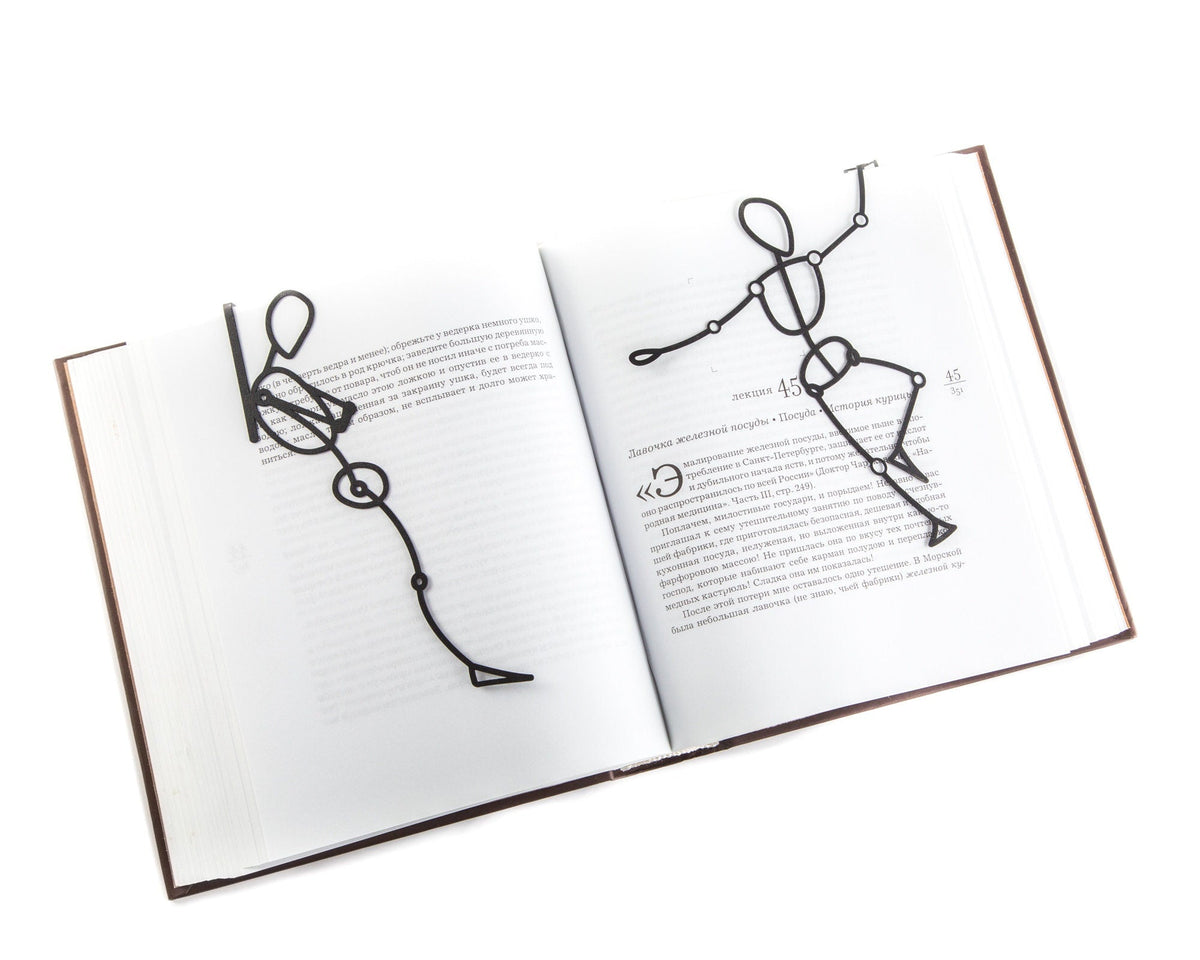 Reading Dummy Model metal bookmark lying across the pages of an open book