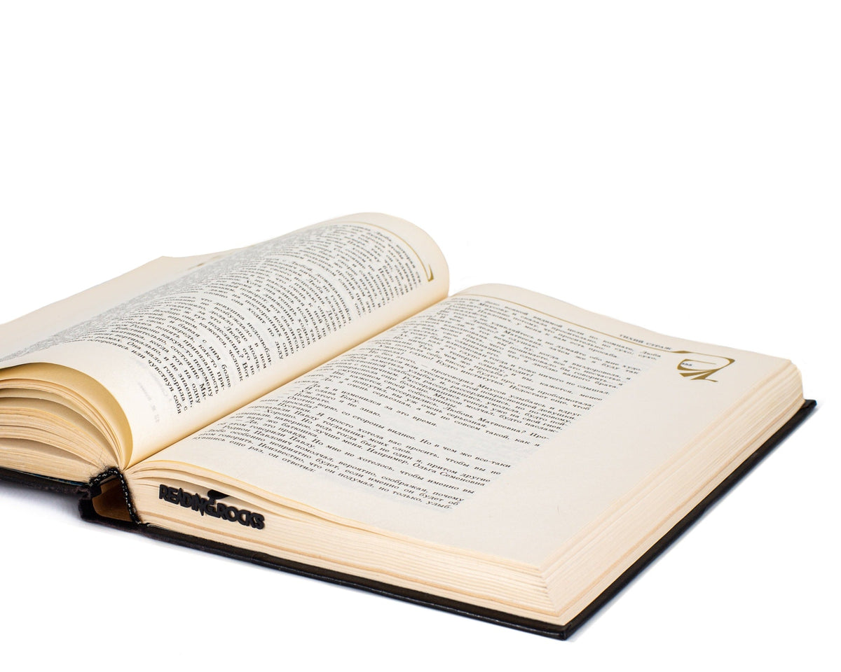 Reading Rocks metal bookmark marking a page in an open book