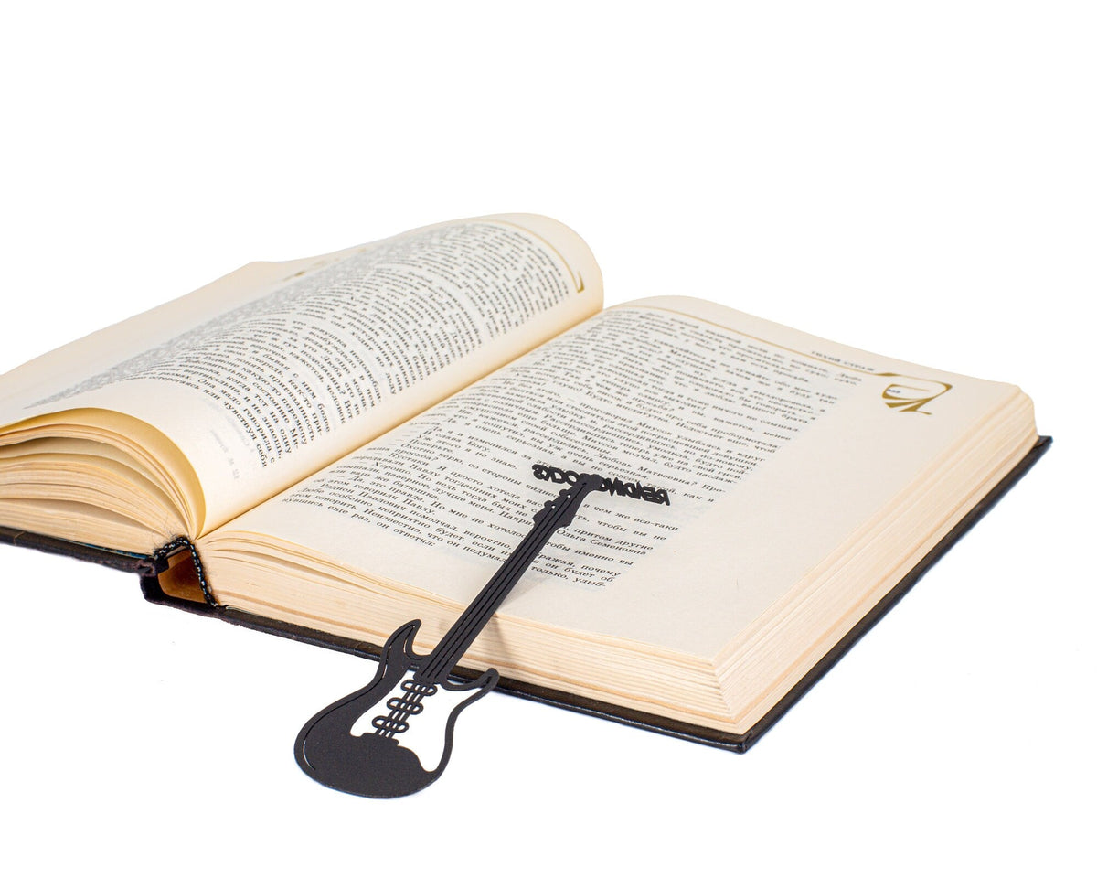 Reading Rocks metal bookmark lying across the pages of an open book