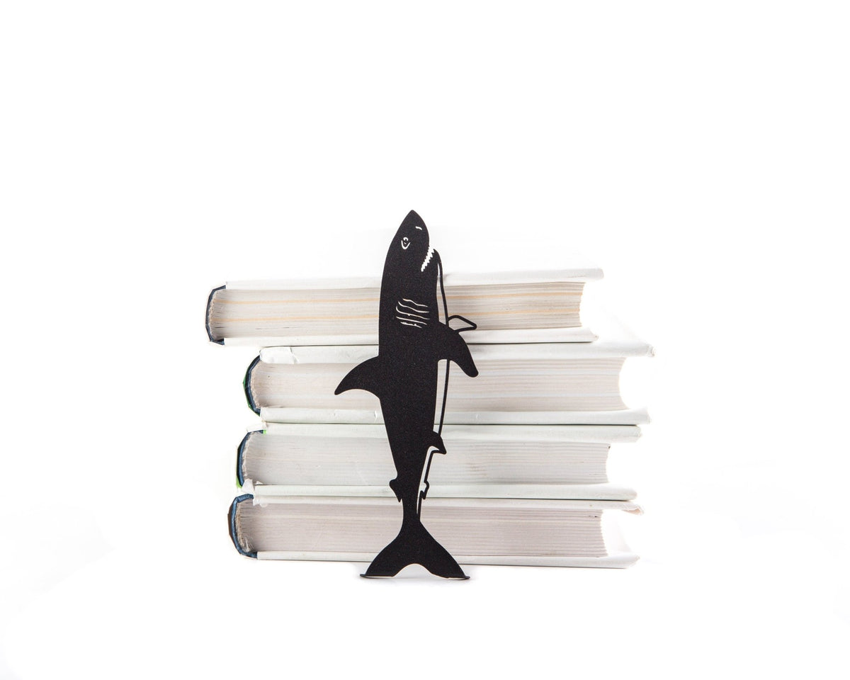 Reading Shark metal bookmark shown with a stack of books