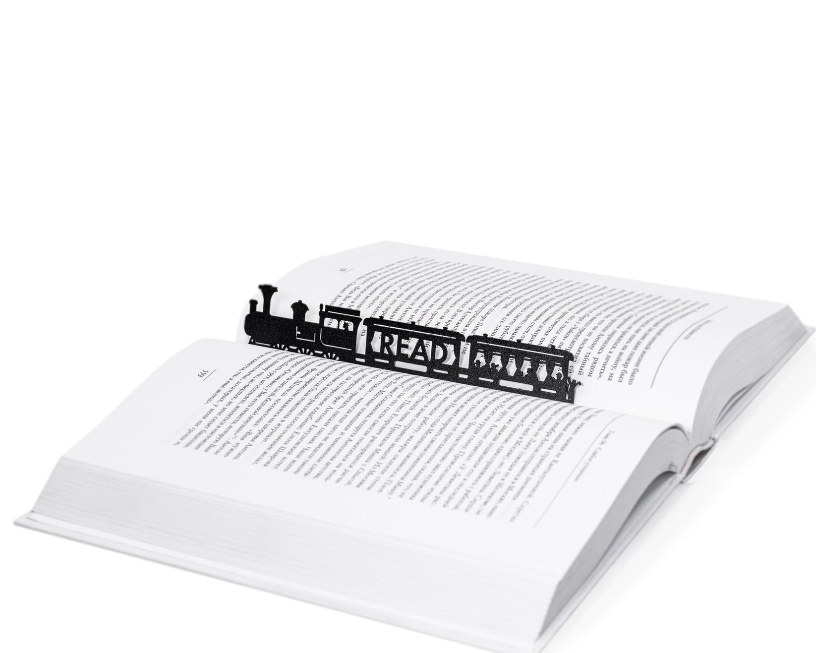 Reading Train metal bookmark resting on the pages of an open book