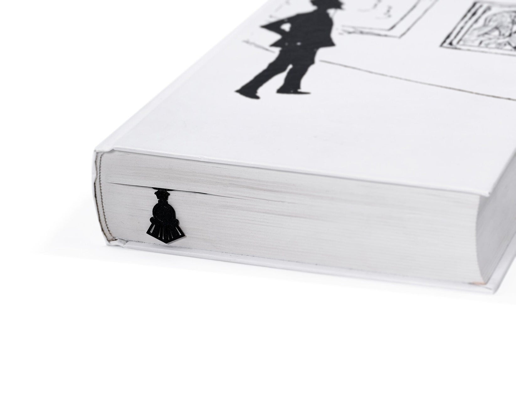 Reading Train metal bookmark in a closed book, only its top showing above the pages