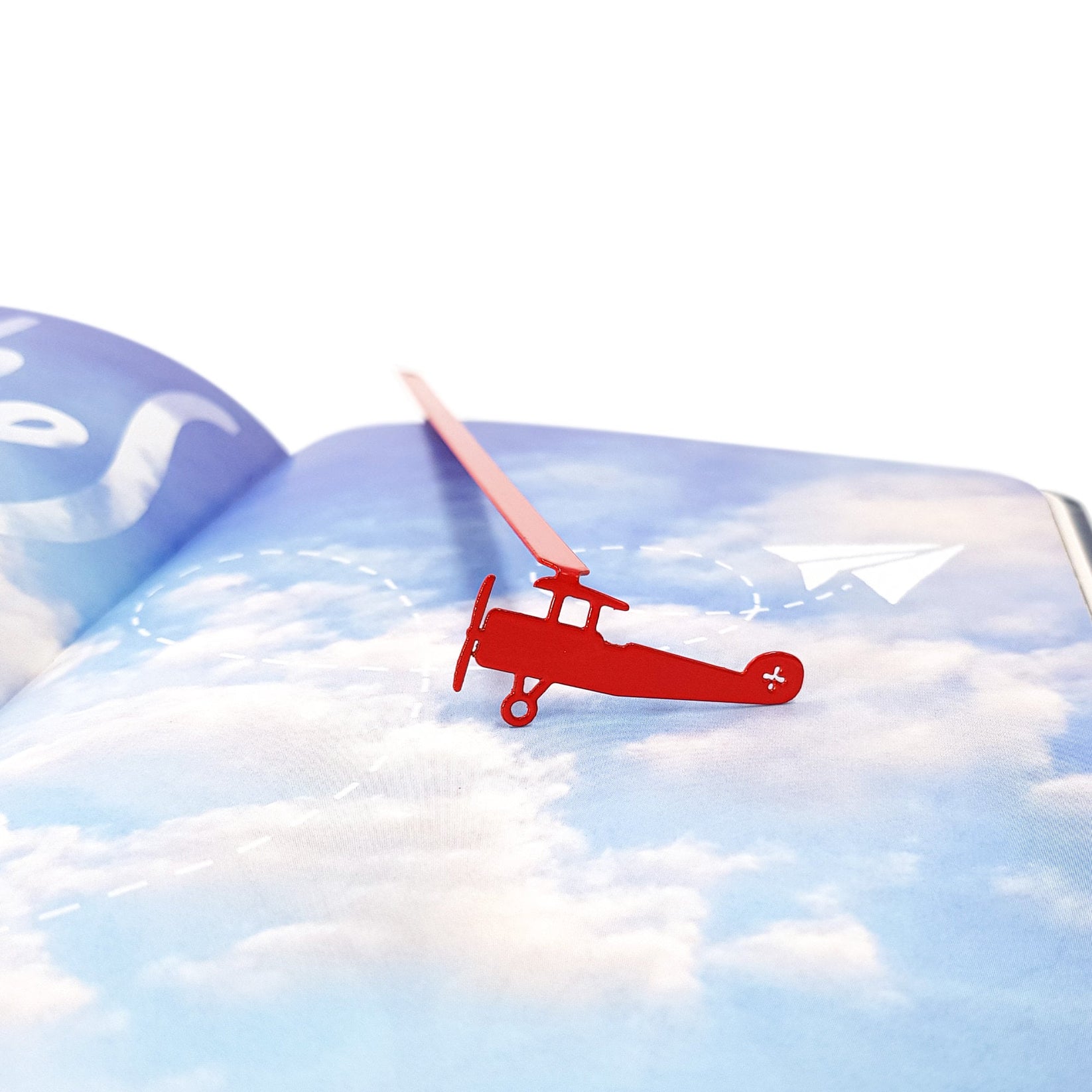 Red Biplane metal bookmark in red on a coloured background