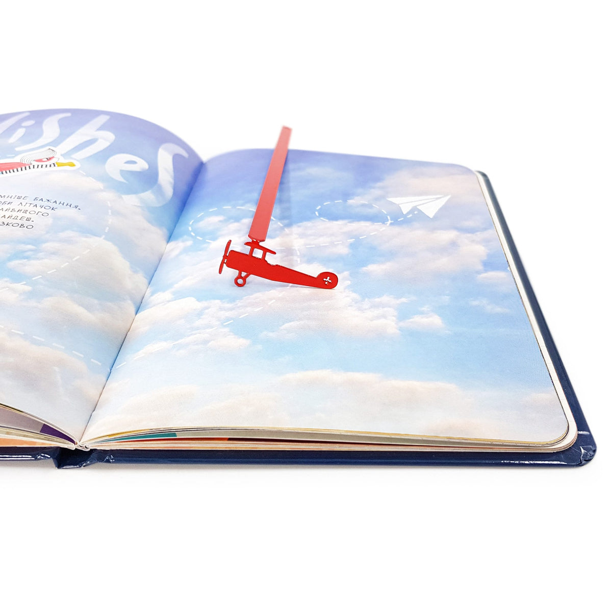 Red Biplane metal bookmark in red on an illustrated page