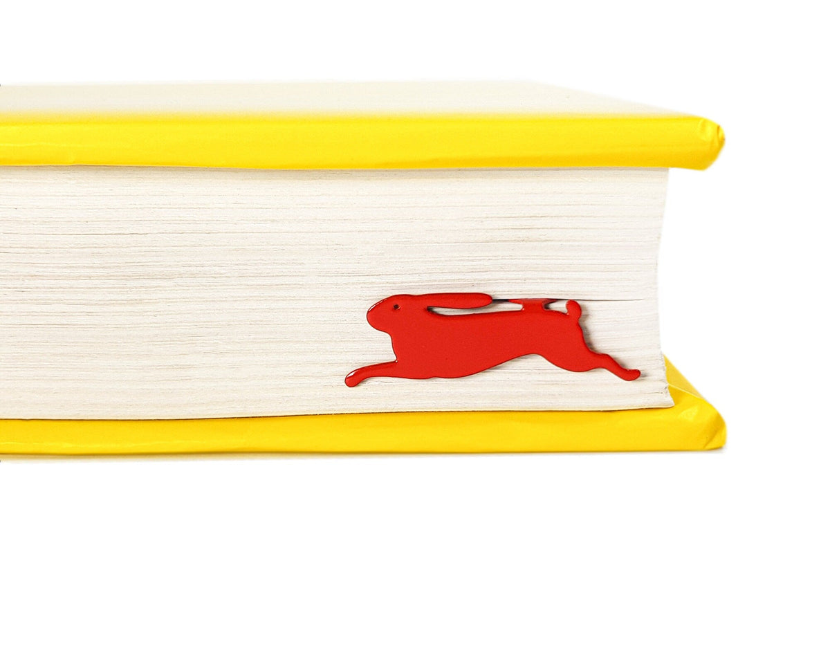 Red Rabbit metal bookmark in red on a coloured background