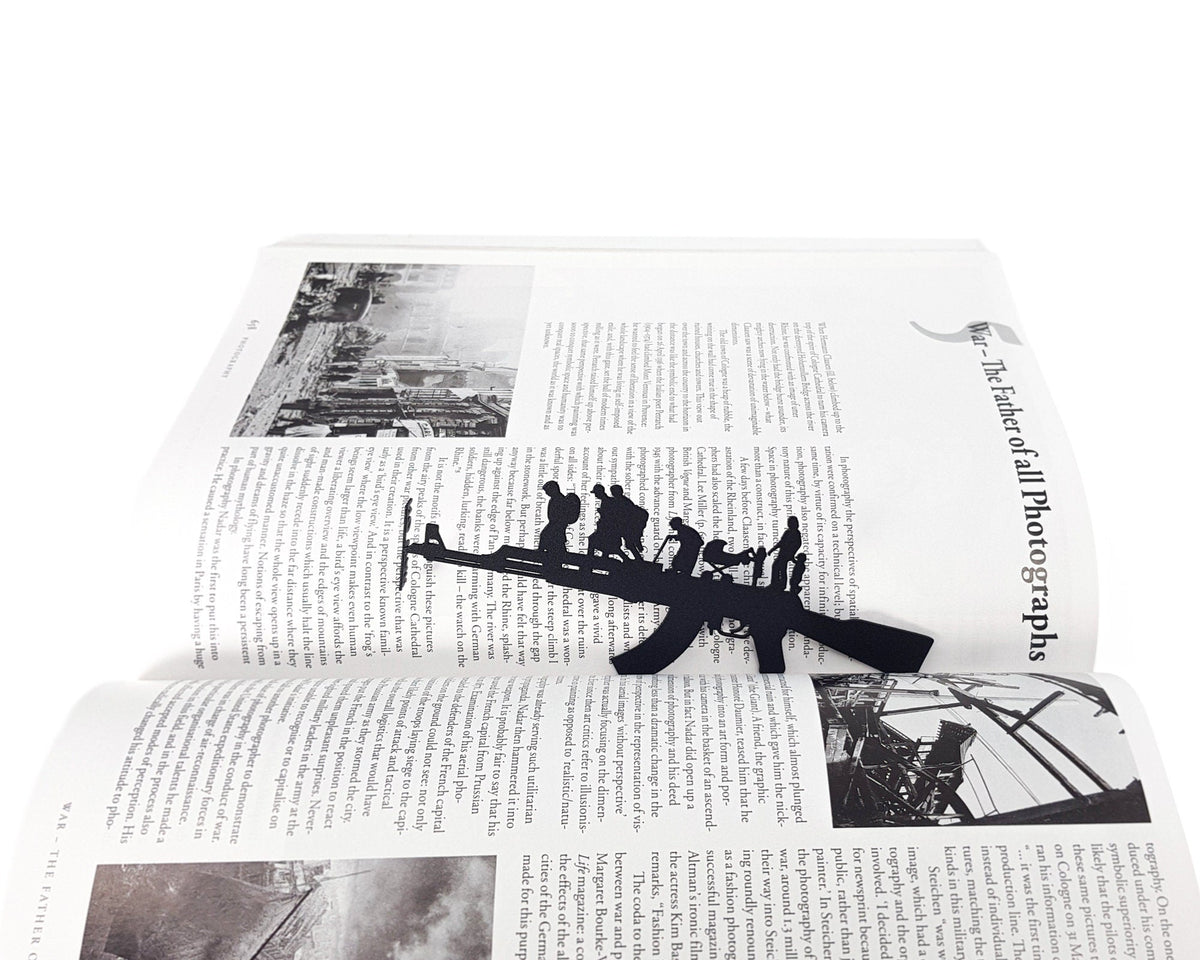 Refugees, No War in Ukraine metal bookmark marking a page in an illustrated book