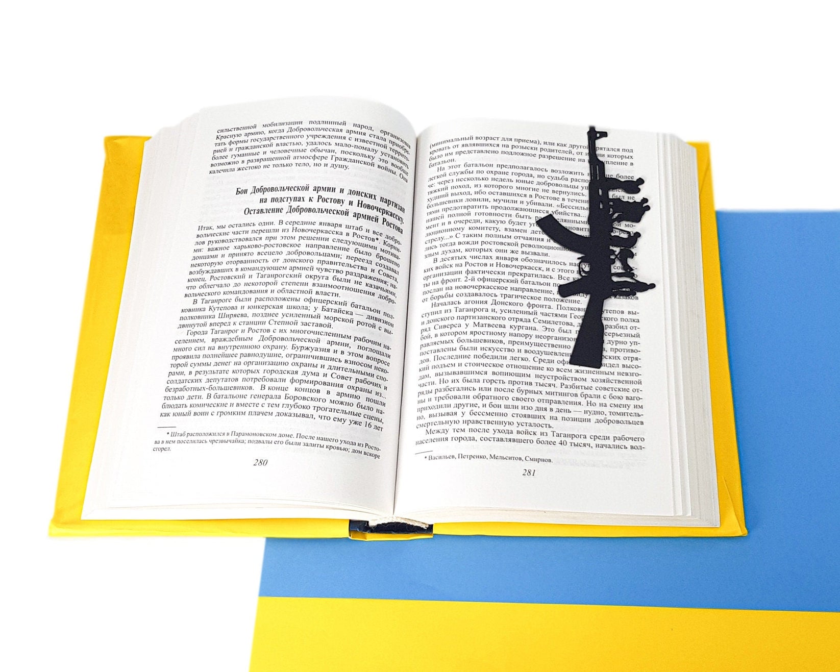 Refugees, No War in Ukraine metal bookmark resting on the pages of an open book