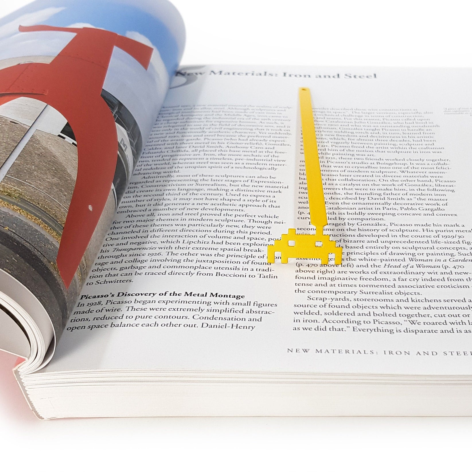 Retro Monster metal bookmark resting on the pages of an open book