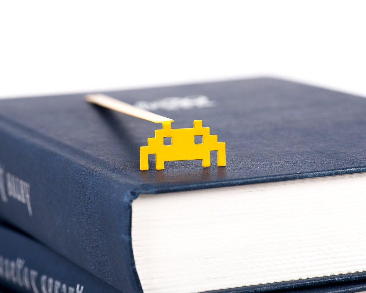 Retro Monster metal bookmark seen from the edge of a closed book