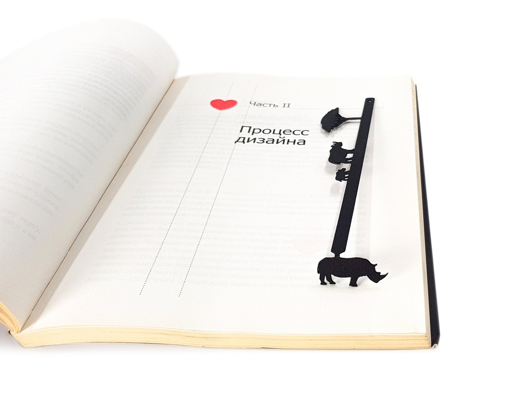 Rhinos metal bookmark resting on the pages of an open book