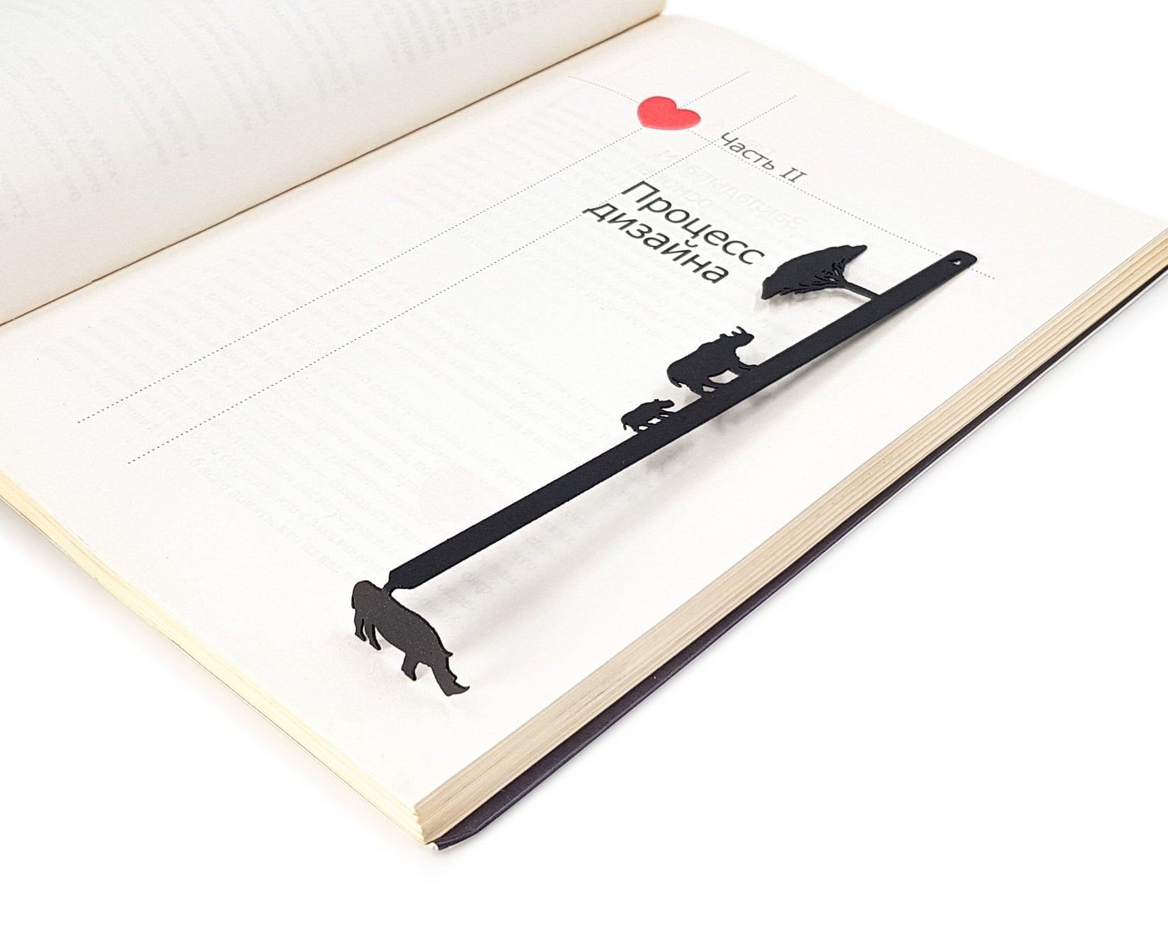 Rhinos metal bookmark marking a page in an open book, view 6