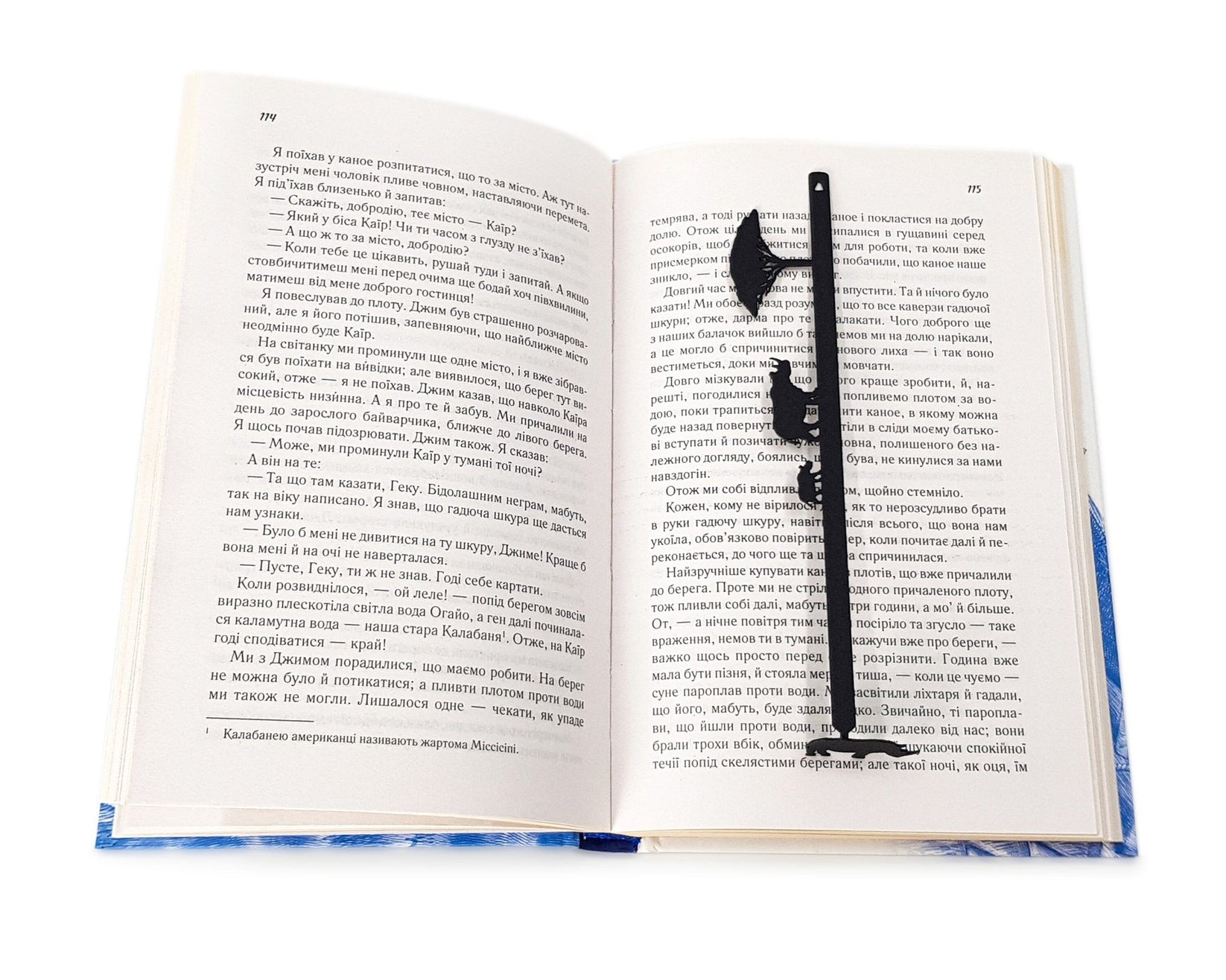 Rhinos metal bookmark lying across the pages of an open book