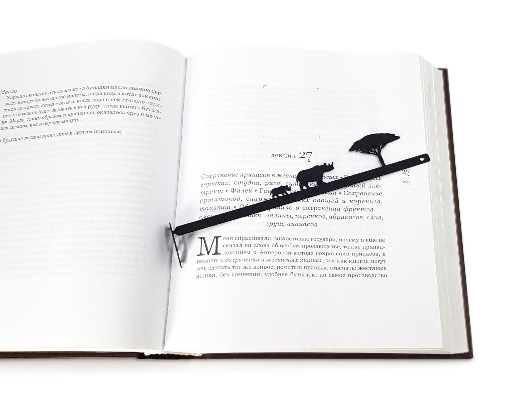 Rhinos metal bookmark marking a page in an open book