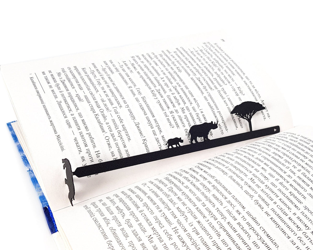 Rhinos metal bookmark set into the gutter of an open book