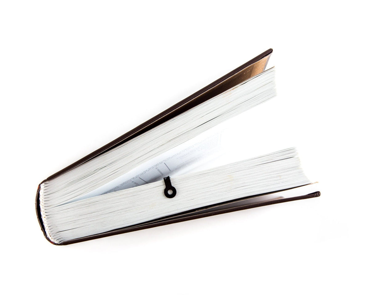 Rocking Horse metal bookmark in a closed book, only its top showing above the pages