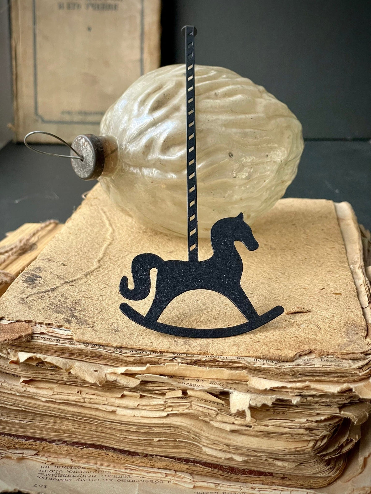 Rocking Horse metal bookmark on a coloured background
