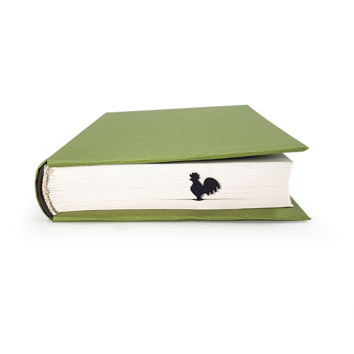Rooster metal bookmark in a closed book, only its top showing above the pages