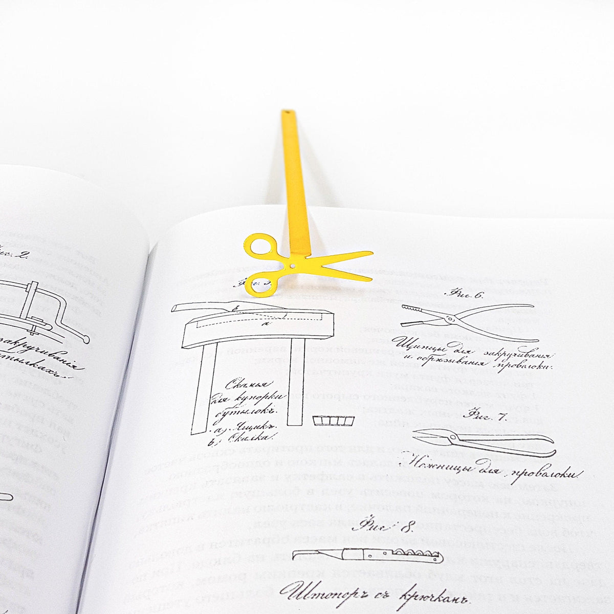Scissors metal bookmark in gold holding a place in a journal