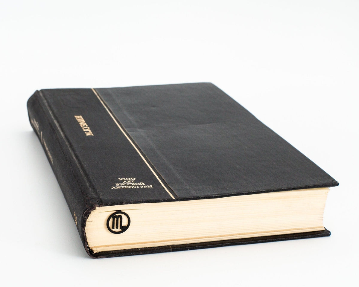 Scorpio metal bookmark in a closed book, only its top showing above the pages