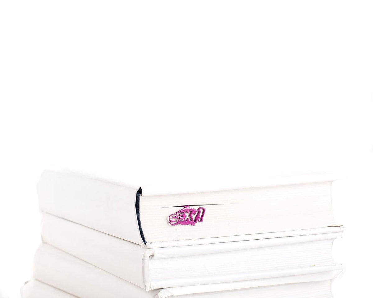 Sexy Smart metal bookmark in a closed book, only its top showing above the pages