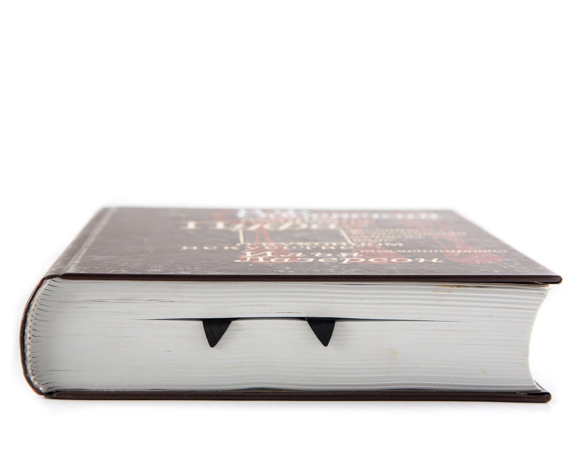 Skis metal bookmark in a closed book, only its top showing above the pages